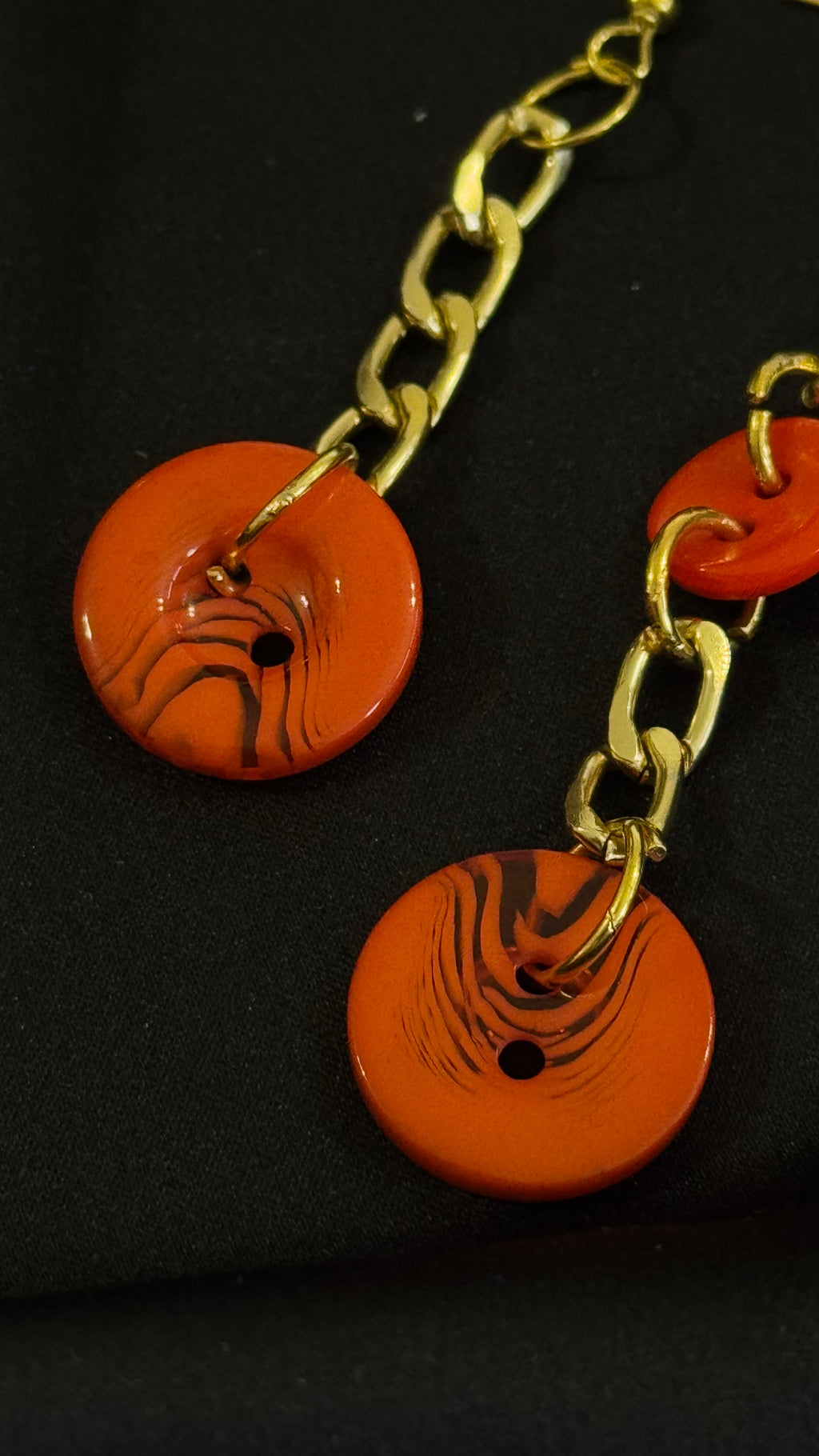 Asymmetrical Orange Buttons Drop